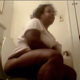 A big black woman takes a shit while sitting on a toilet and then wipes her ass. No poop is seen. Over 7 minutes.